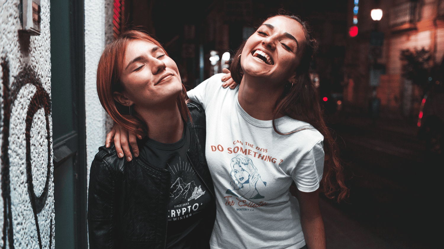 Two girlfriends wearing NFT T-shirts walking down the streets looking happy